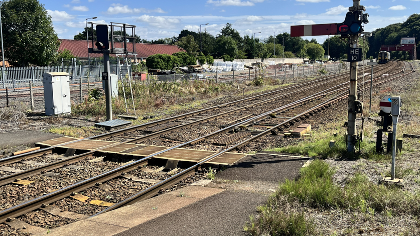 A picture of a barrow crossing which is a flat piece of wood which allows people to cross the track without actually walking on the tracks