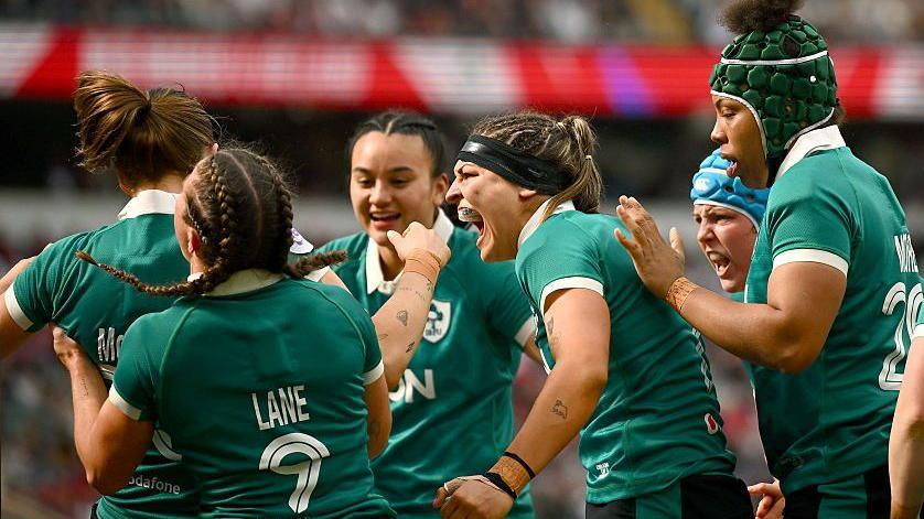 Ireland players celebrate their side's first try, scored by Anna McGann