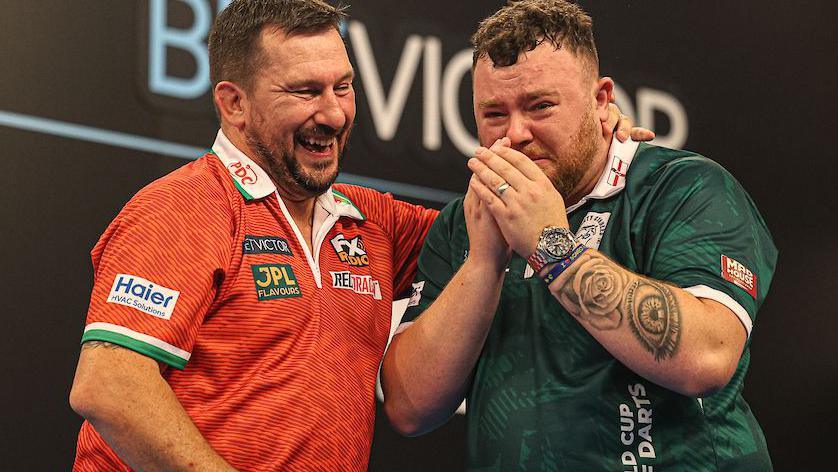 Jonny Clayton congratulates a tearful Jonny Clayton after the World Cup of Darts final