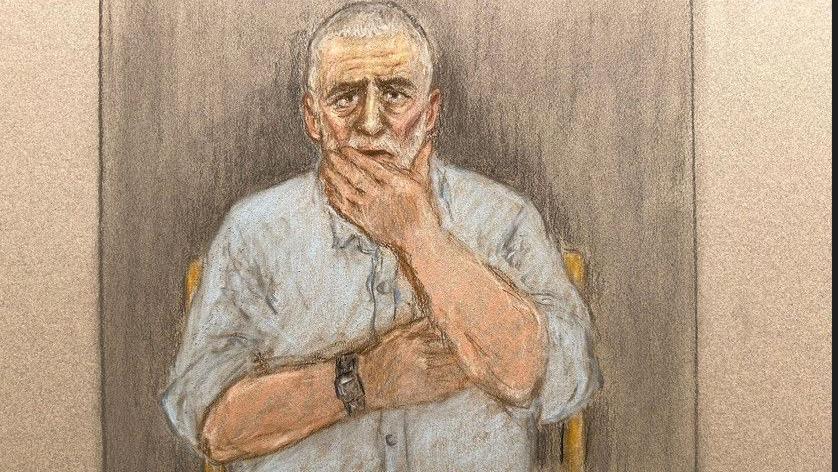 A court sketch showing Peter Sullivan, 68, who has grey and white hair and a blue shirt, holding his hand to his face
