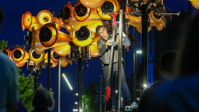 A man plays an instrument crafted from repurposed air raid sirens.