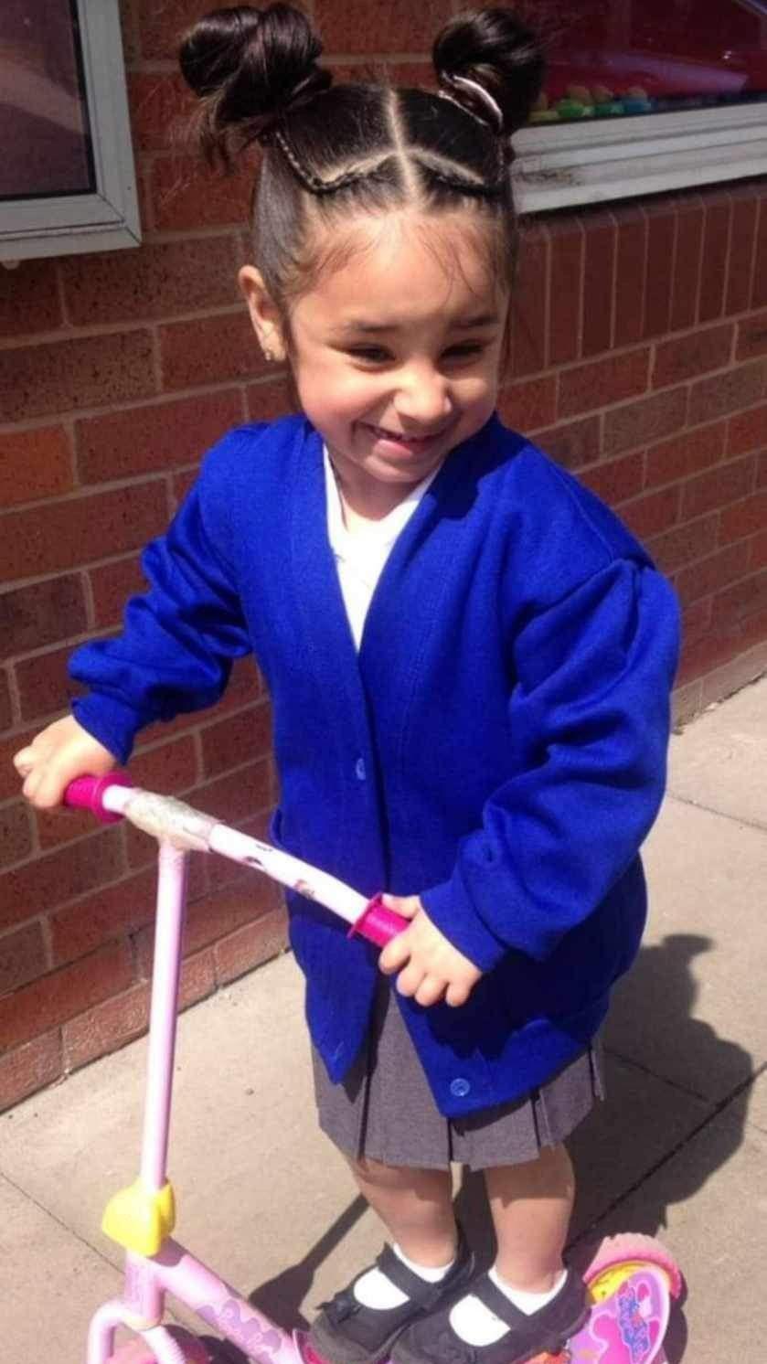 A young Shay on a scooter