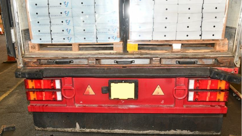 A photo taken by the National Crime Agency of the lorry the cannabis was transported on. Three metal drawers are in a compartment underneath two pallets carrying boxes of chicken.