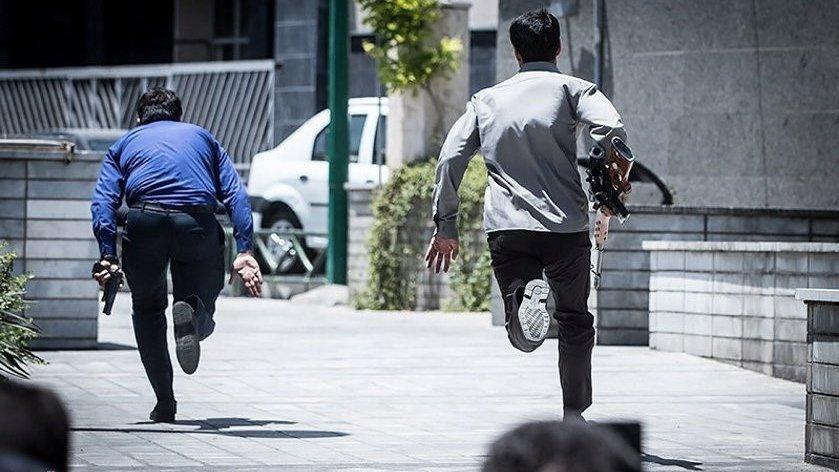 Members of Iranian forces run during an attack on the Iranian parliament in central Tehran, Iran, June 7, 2017.