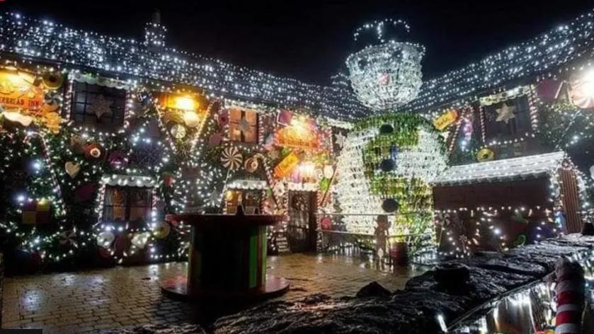 The pub covered in Christmas lights with the theme of the Gingerbread Man  and a giant snowman made of 2,500 wine bottles.