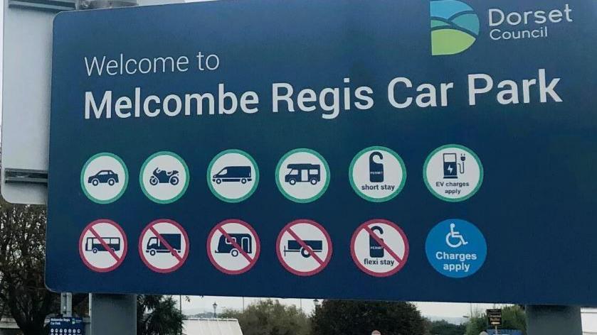 A sign reading Welcome to Melcombe Regis Car Regis from Dorset Council 