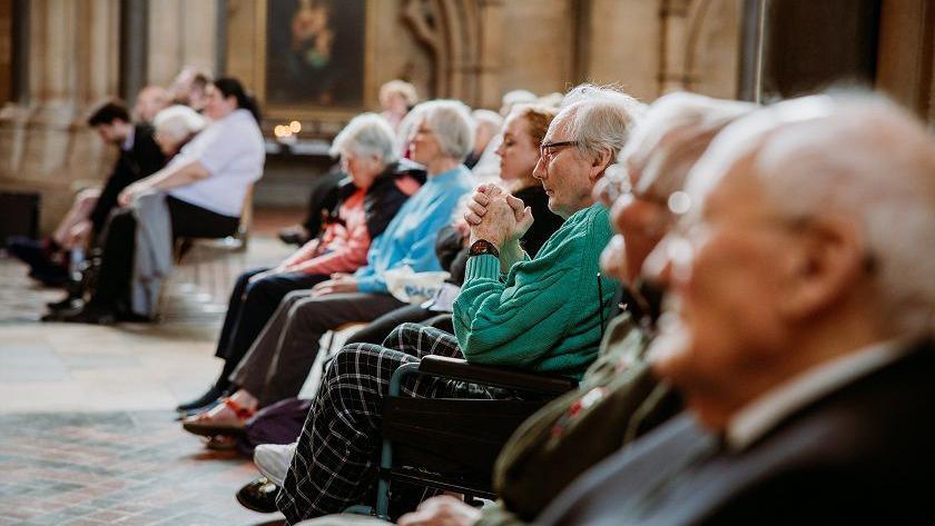 Care home residents sitting in the audience at Bristol Cathedral