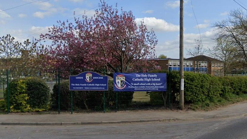 Holy Family Catholic High School sign outside school building