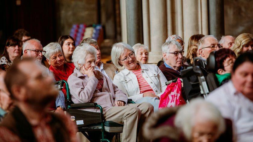 Care home residents sitting in the audience