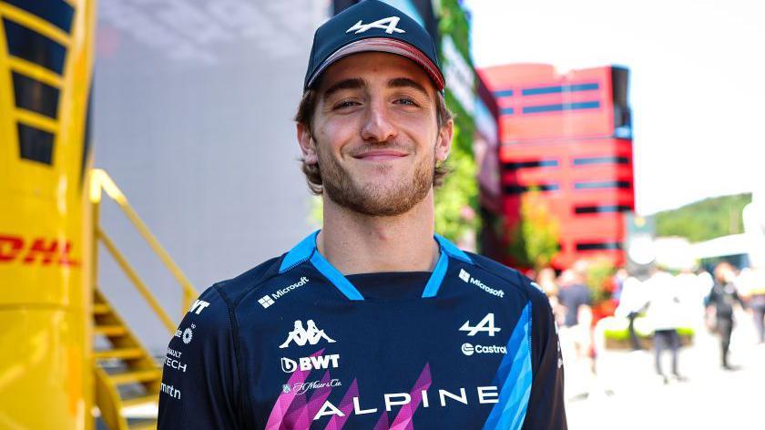 Jack Doohan smiles in Alpine hat and shirt