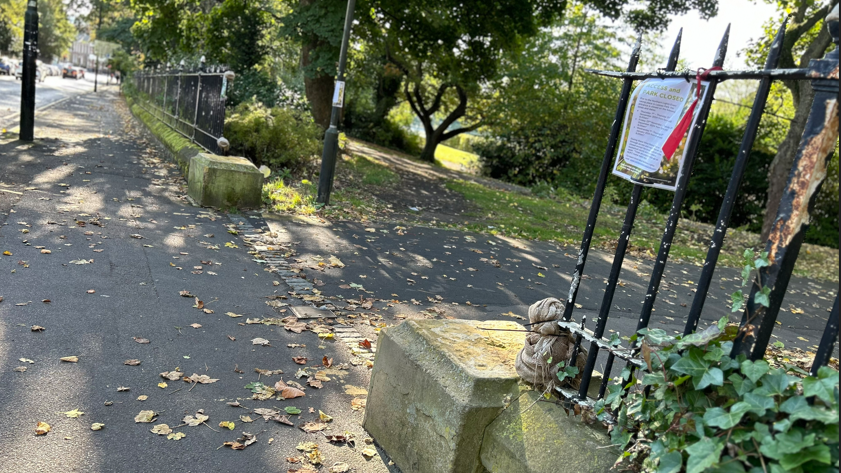 One of the entrances to Leazes Park with railings on either side. Two concrete bases are on either side of the entrance but are missing the plinths 