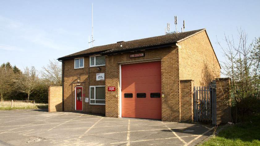 The current Howden Fire Station, a two-storey building with three windows and a door on one side and a fire station sign and sliding door on the other