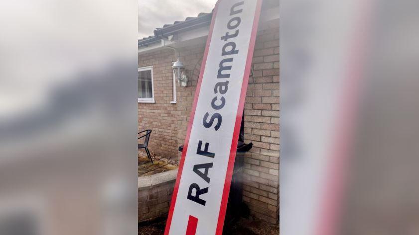 The RAF Scampton sign propped up against the side of Steve Jollands's bungalow to show it is higher