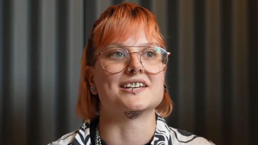 Kit Bagnall wearing a zebra print shirt with red hair and glasses