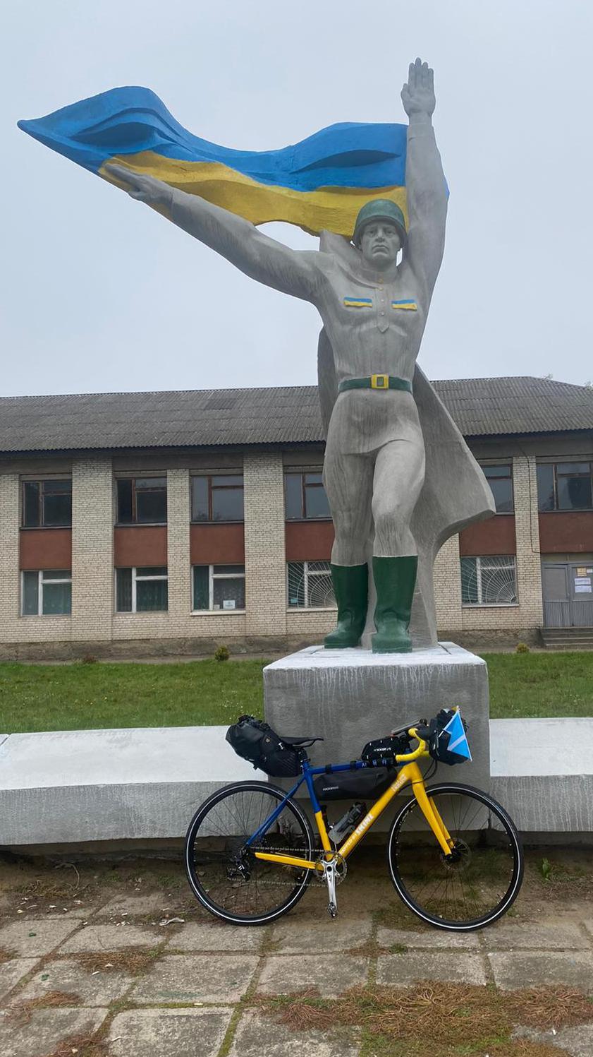 Andrea Fraser's bike next a statue in Ukraine