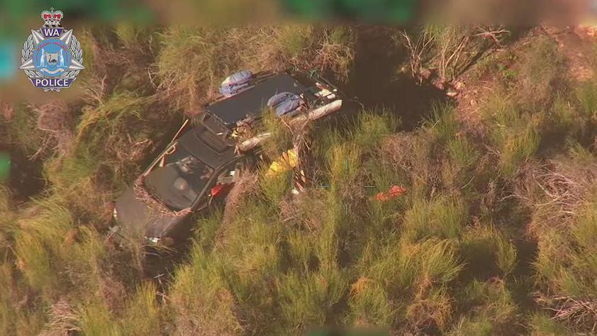 A police handout photo shows a dark coloured van surrounded by green and brown bushland.