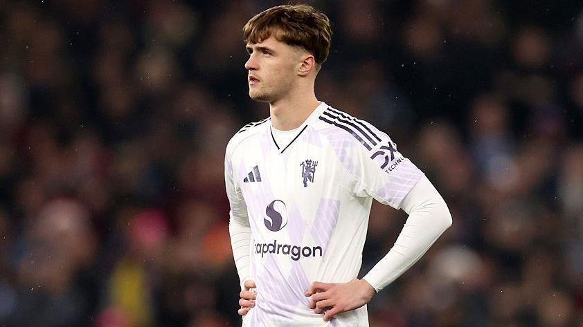 Manchester United's Jack Fletcher stands with his hands on his hips during a match
