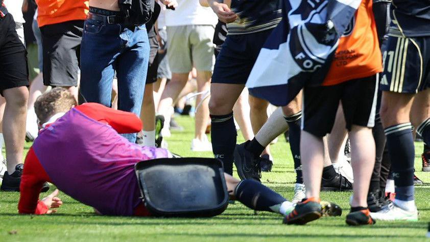 Aberdeen's Jack MacKenzie (L) after being struck by an object thrown from the crowd during a William Hill Premiership match between Dundee United and Aberdeen at the CalForth Construction Arena at Tannadice Park