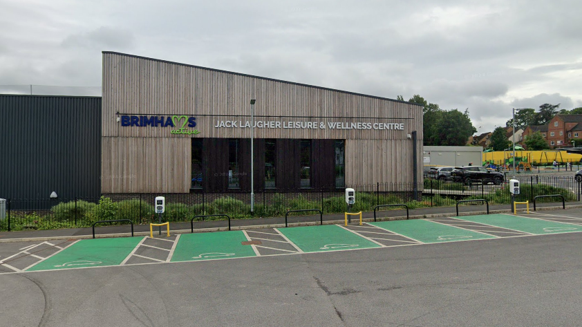 Jack Laugher Leisure Centre in Ripon, with a wooden frontage and charging points for electric vehicles in the foreground.