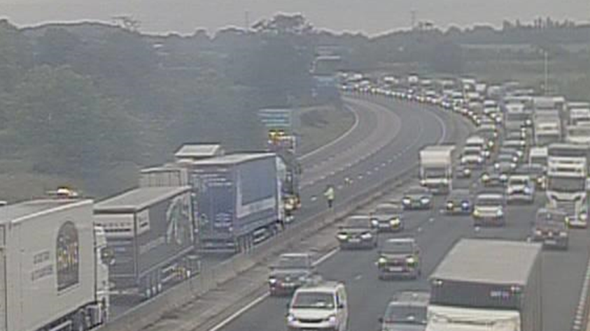 A high up view of the traffic stopped on the lanes of the motorway