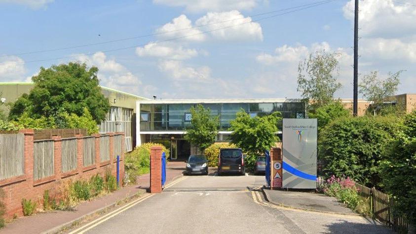 The entrance of a car park with a silver totem to the right hand side with the South Staffordshire College logo at the top