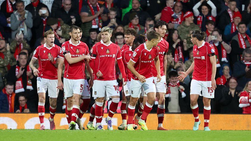 Wrexham players celebrate the goal of Josh Windass (3rd from left)
