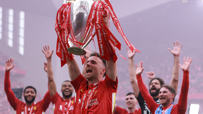 Liverpool's Diogo Jota celebrates with the Premier League trophy at Anfield in May