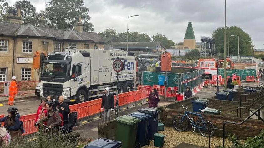 View of roadworks on Botley Road with orange plastic barriers lining the street