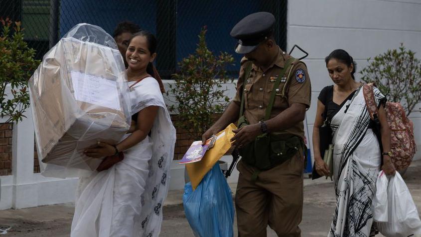 Election officers carry a sealed ballot box to a counting center during the presidential election in Colombo, Sri Lanka, on Saturday, Sept 21, 2024. 