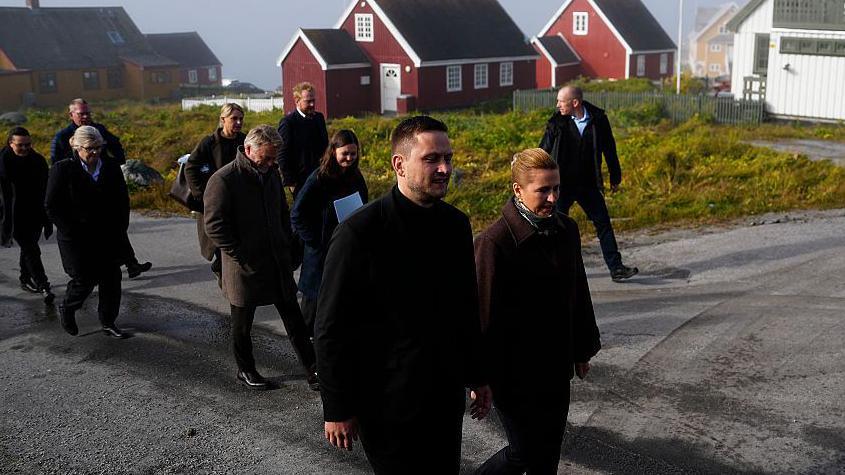 Greenland's head of government, Jens-Frederik Nielsen (L) and Denmark's Prime Minister Mette Frederiksen arrive at the Katuaq cutural house in Nuuk, Greenland