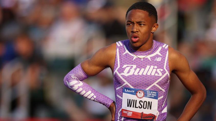 A picture of Quincy Wilson after a race, wearing a purple running vest