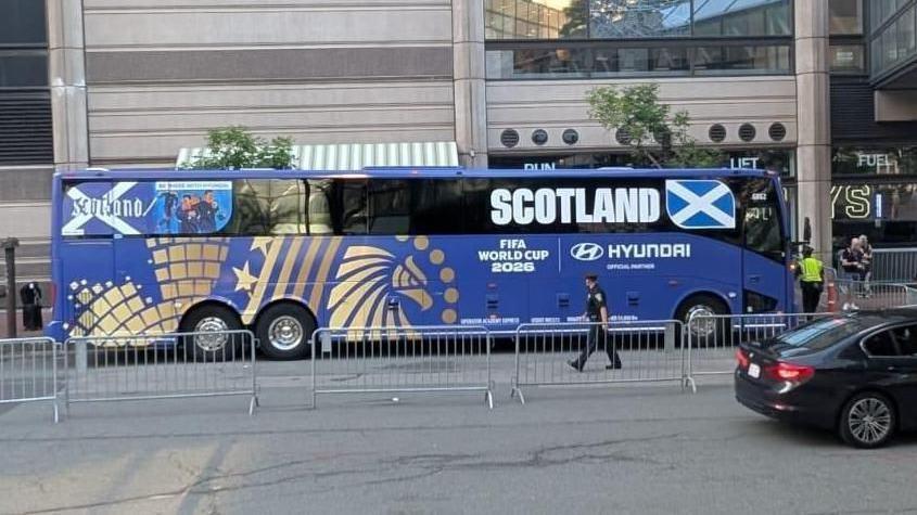 The Scotland team bus, blue with the word Scotland on the side. A small design saying Scotland with a Saltire and illustration is at the rear of the bus.