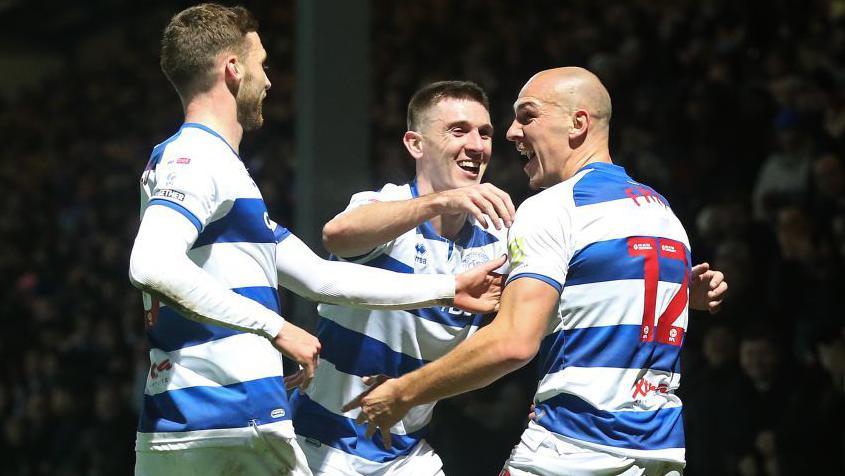 Sam Field [left], Jimmy Dunne [centre] and Michael Frey [right] celebrate after Frey scores for QPR against Luton Town