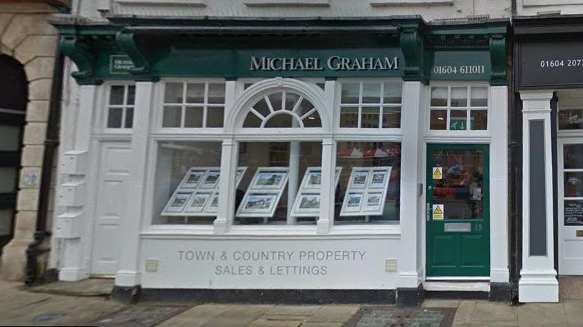 Estate agents' window with property details