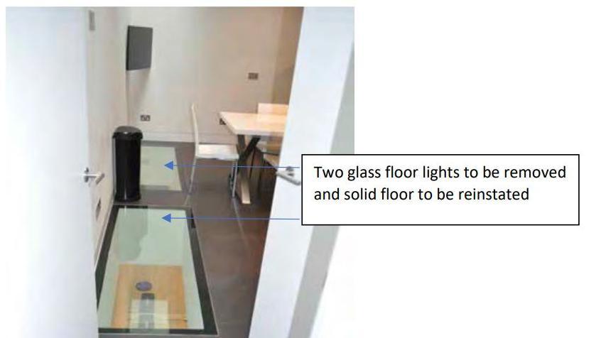 A screenshot of the council's enforcement notice, showing a photograph of two glass ceiling lights and an annotation from the council to say they must be removed and a solid floor reinstated