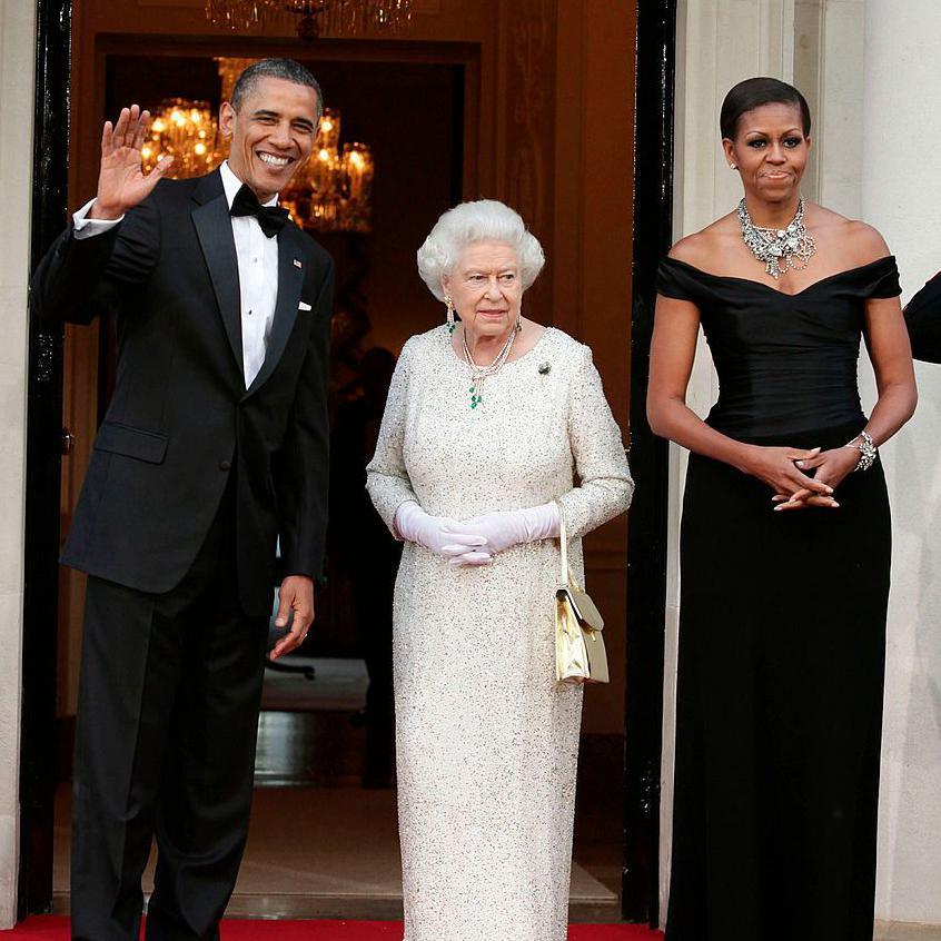 Queen Elizabeth II stands between Barack and Michelle Obama