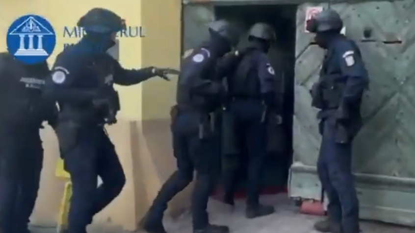 Police entering a building in Romania