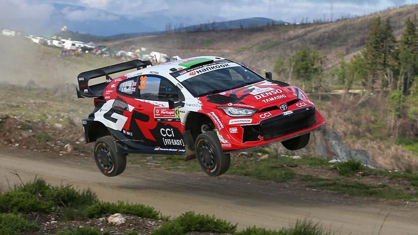 Elfyn Evans' Toyota Yaris takes to the air on a gravel track at the 2026 Rally de Portugal