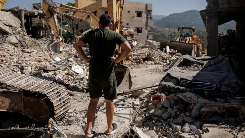 A man looks at destroyed houses amid ongoing search for survivors, a day after an Israeli strike on residential buildings in Maaysrah, north of Beirut, Lebanon.