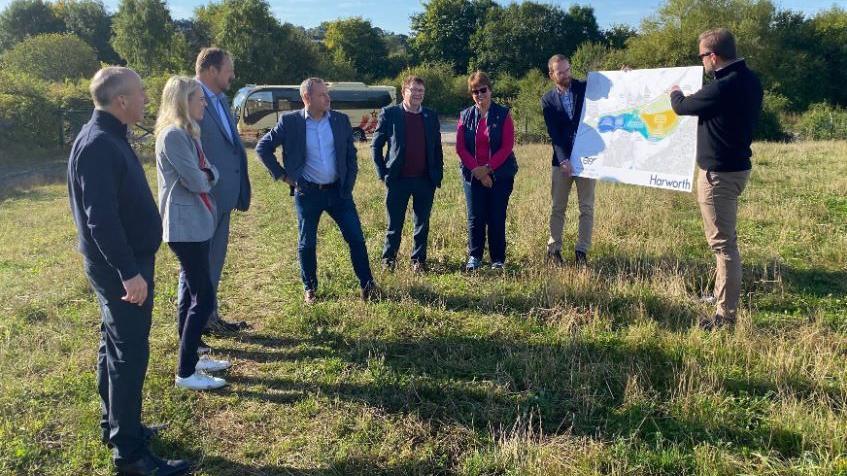 Developers, Chesterfield Borough Council leader Tricia Gilby and MPs Louise Jones and Toby Perkins look at prospective plans for the scheme in a field where a bypass would go