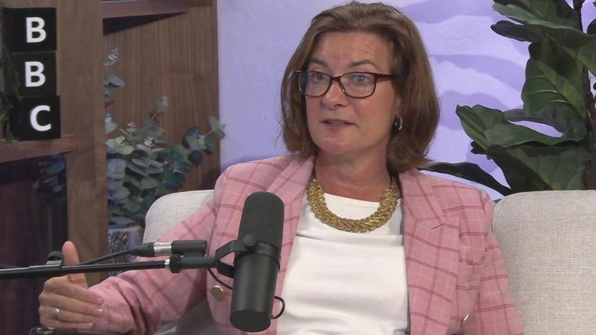 Eluned Morgan speaking into a microphone in the Newscast studio