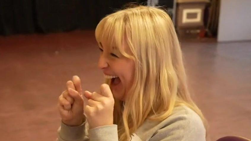 Ms Roper celebrates with her hands in front of her face. 