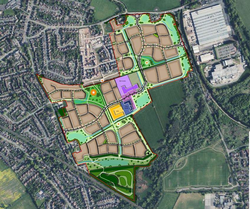 An aerial view of land to be included in the housing development, with areas marked in brown, green purple and yellow.