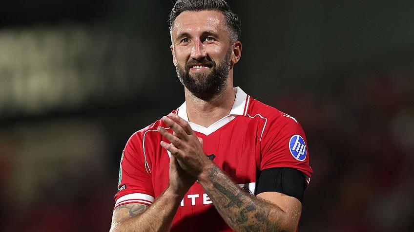 A smiling Ollie Palmer applauds Wrexham's fans