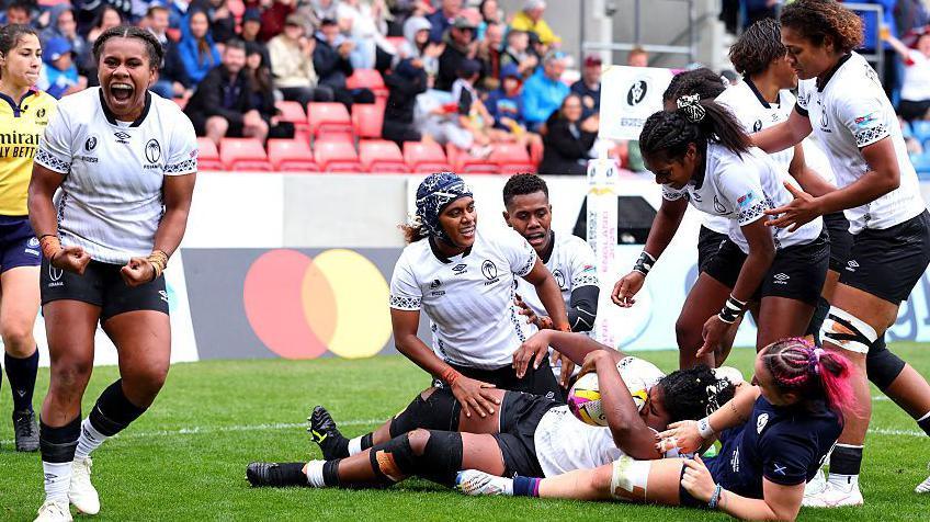 Fiji celebrate scoring a try against Scotland
