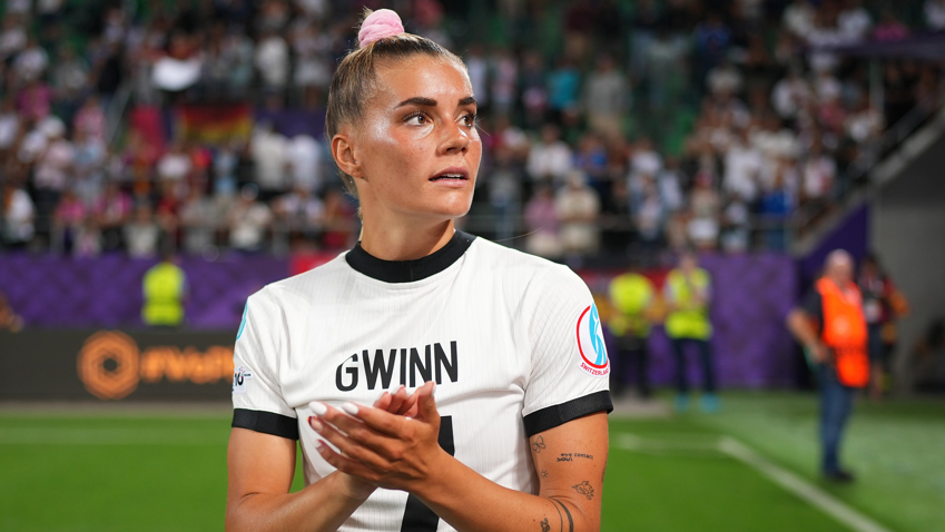 Germany's Selina Cerci wears nan garment of injured team-mate Giulia Gwinn arsenic she applauds fans aft her country's 2-0 Group C triumph complete Poland astatine Euro 2025
