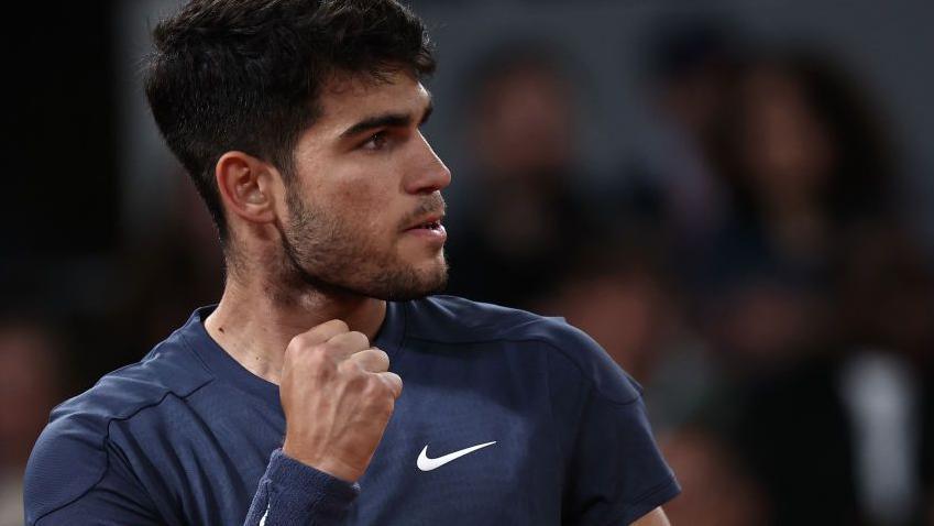 Carlos Alcaraz celebrates winning a point at the French Open