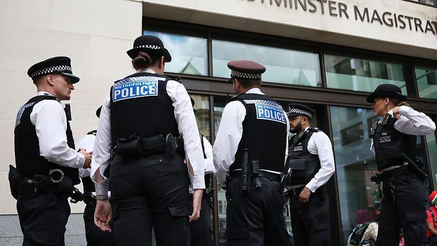 Police officers seen during a demonstration outside Westminster Magistrates' Court