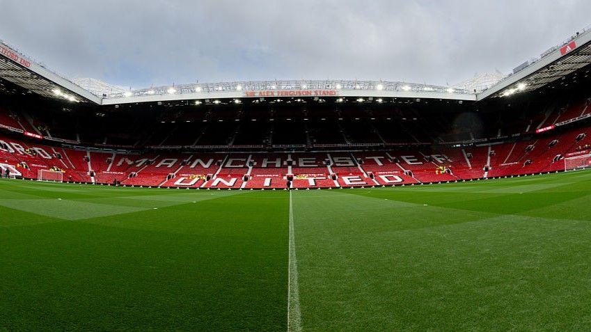 Three sides of Manchester United's Old Trafford stadium when empty