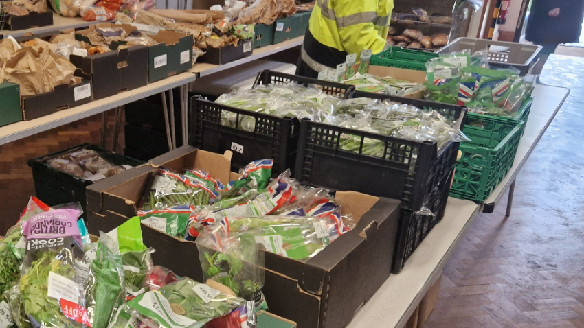 a long trestle table covered with fresh food